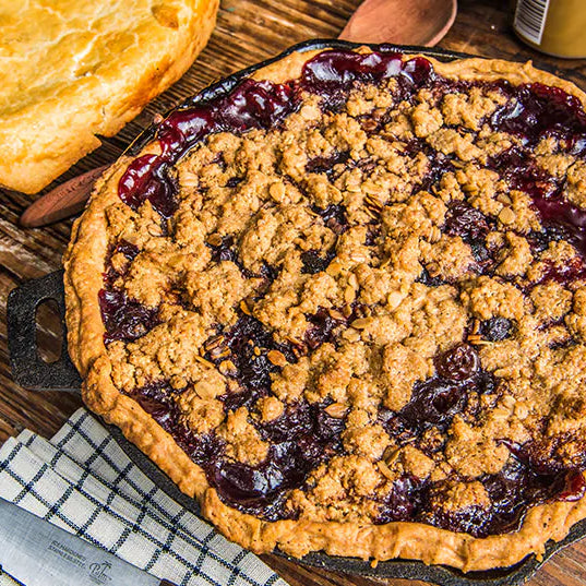 Cherry Bourbon Pie on a wood cutting board